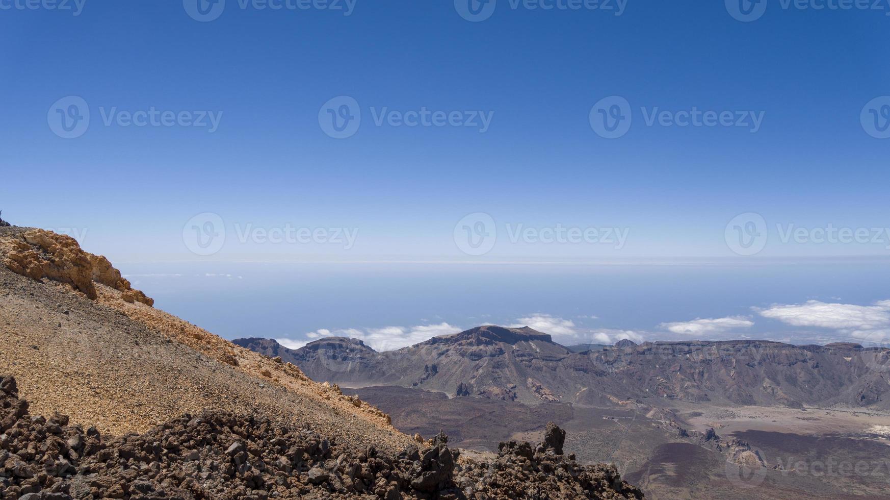 View from Teide Las Canadas Caldera volcano with solidified lava. Teide national Park mountain landscape above the clouds. Tenerife, Canary Islands, Spain. photo