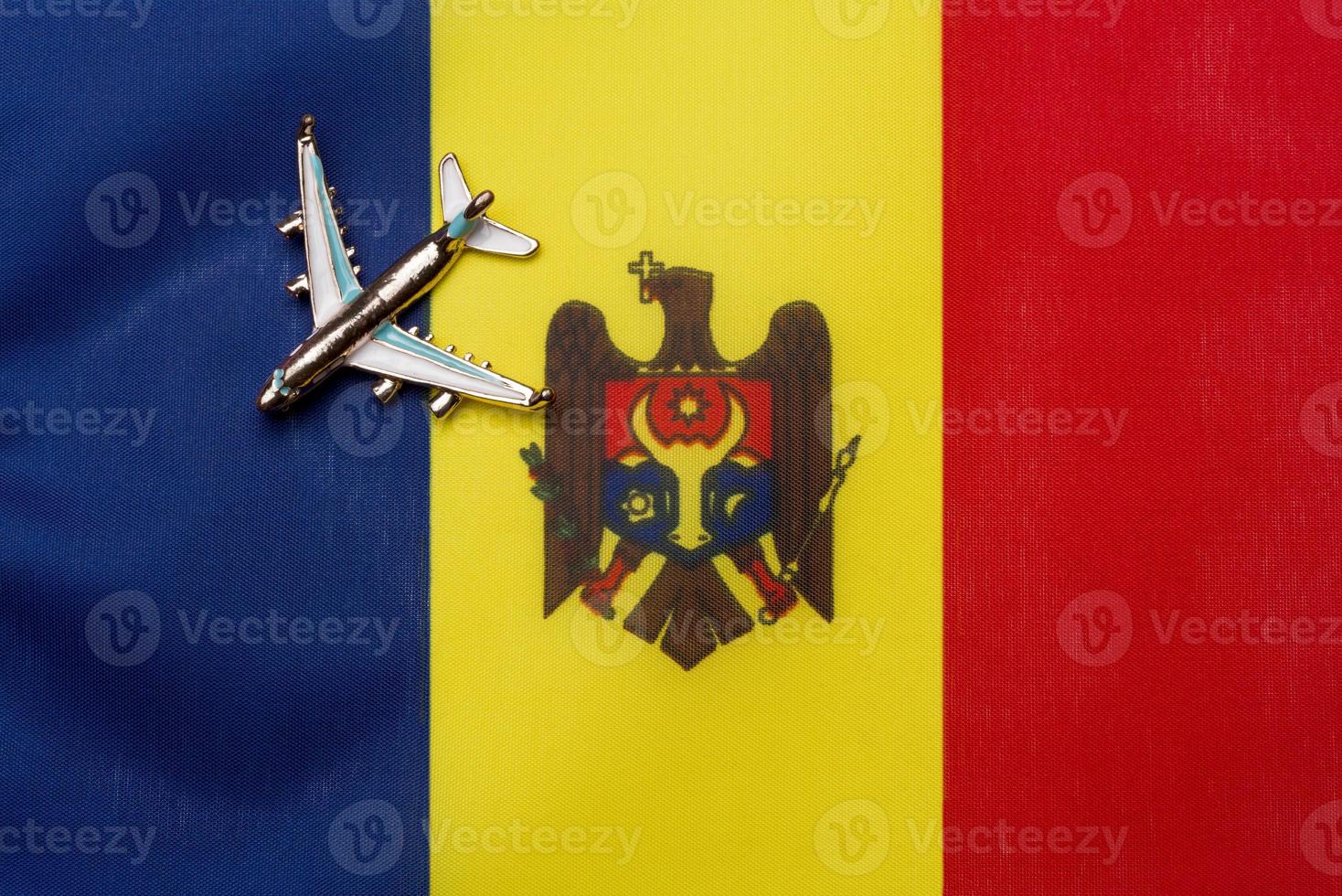 The plane over the flag of Moldova is the concept of travel and tourism. photo