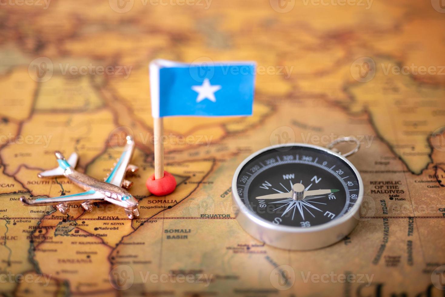 Airplane flag, compass and airplane on the world map and airplane. photo