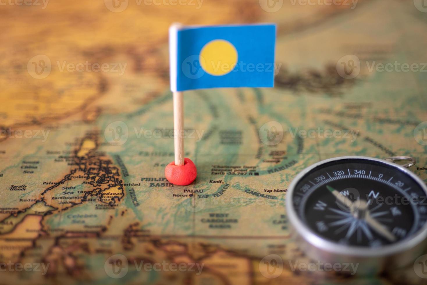 Flag of Palau compass on the world map. photo