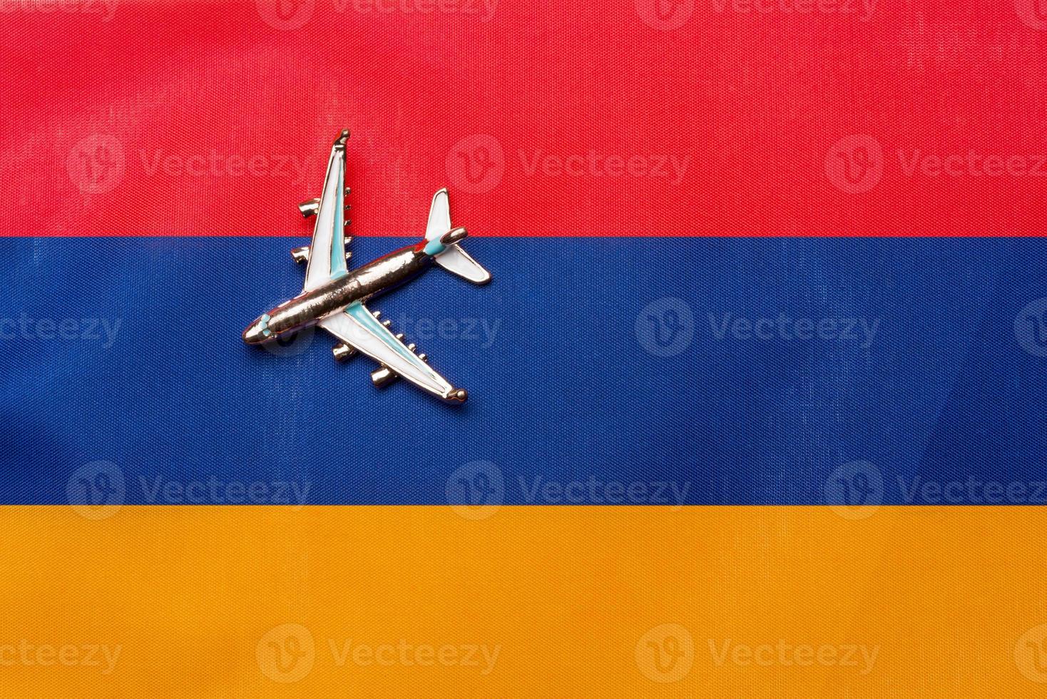 Plane over the flag of Armenia, the concept of journey. photo