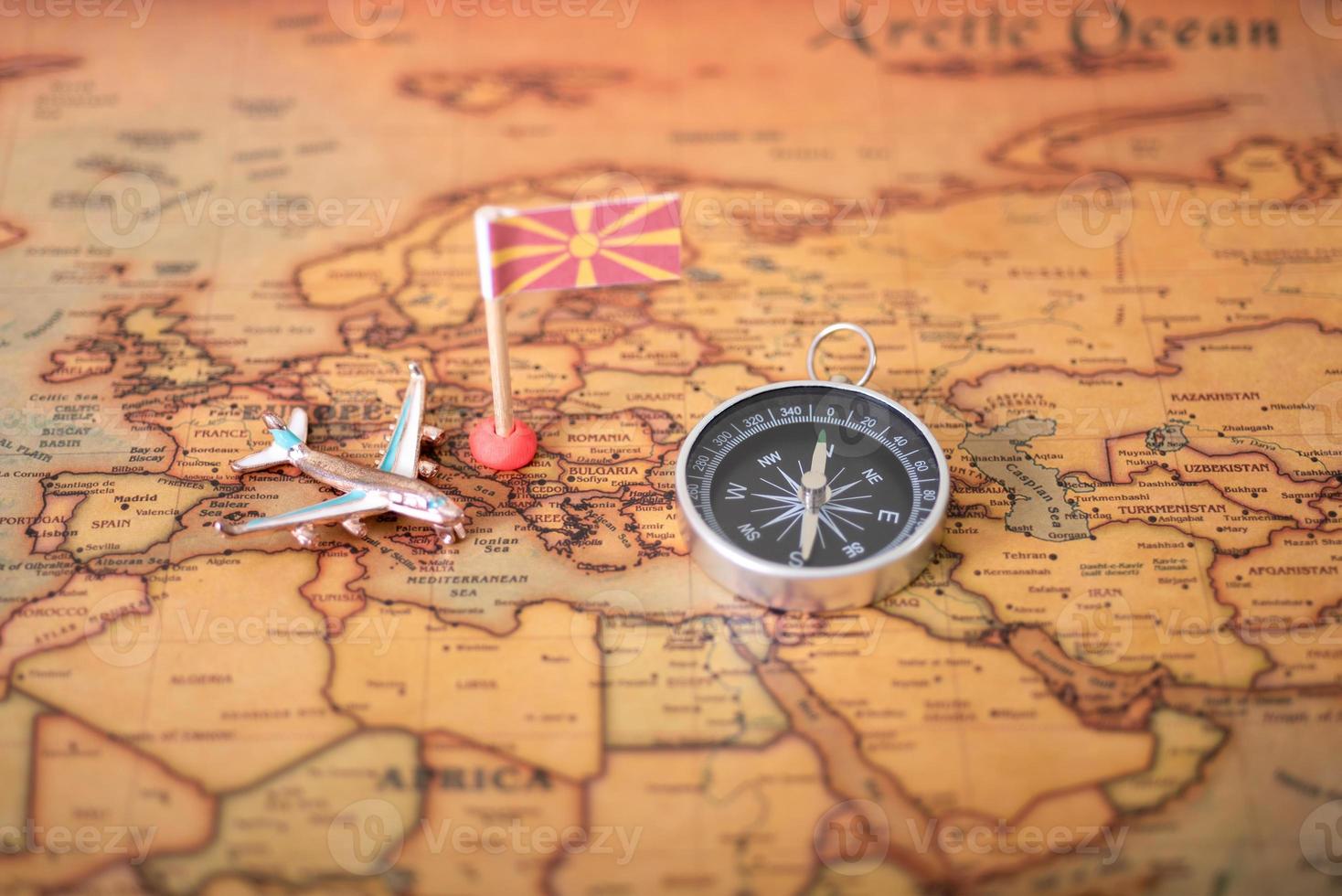 Flag of Macedonia, compass and airplane on the world map. photo