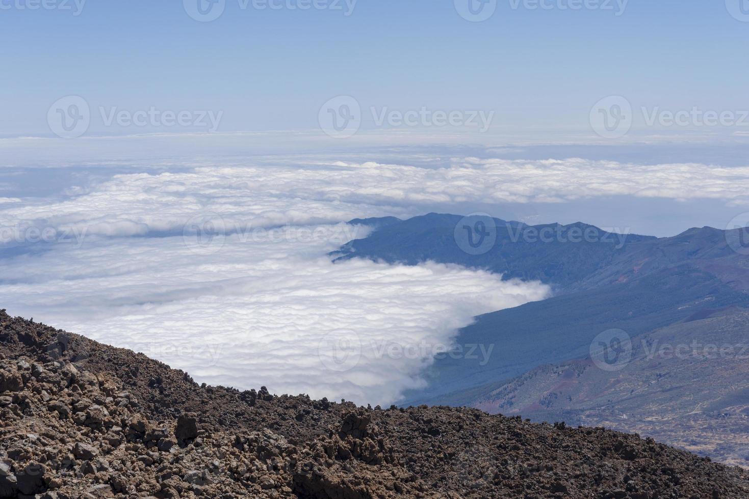 View from Teide Las Canadas Caldera volcano with solidified lava. Teide national Park mountain landscape above the clouds. Tenerife, Canary Islands, Spain. photo