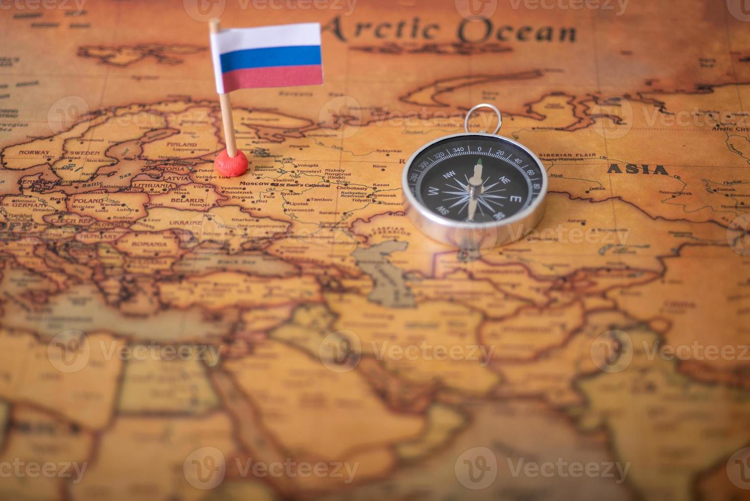 Airplane flag and compass on the world map and airplane. photo