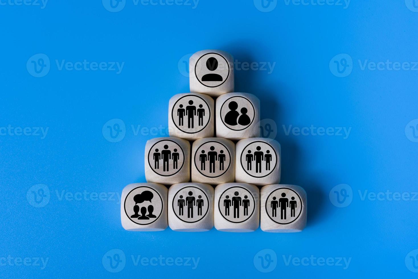 Boss concept with icons on wooden cubes, blue background. photo