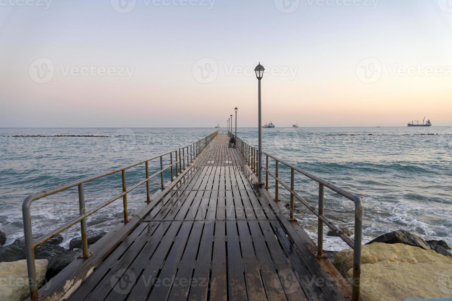 Wooden pier in Limassol overlooking the sea. photo