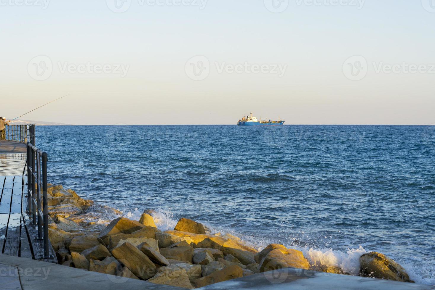 Mediterranean waves beat the shore near the city of Limassol in Cyprus. photo