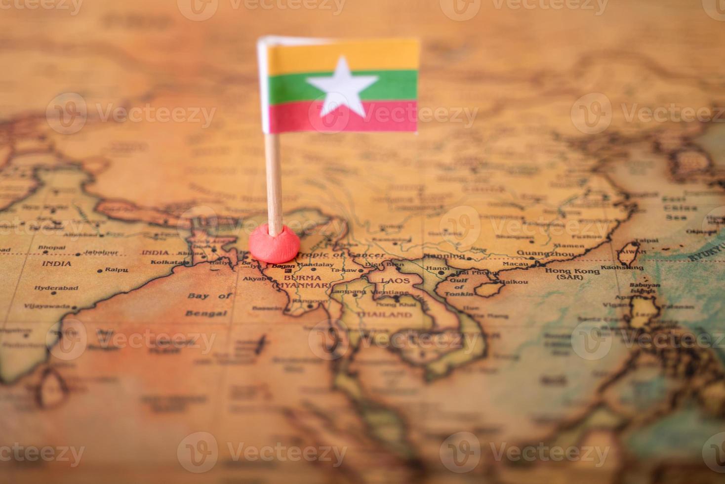 The flag of Myanmar on the old world map. photo