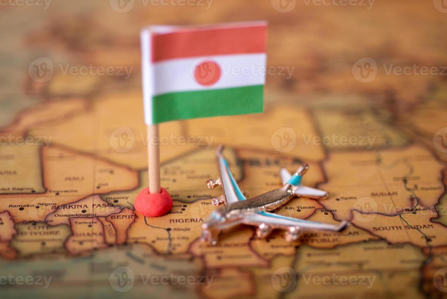 the flag of Niger and the plane on the world map. photo