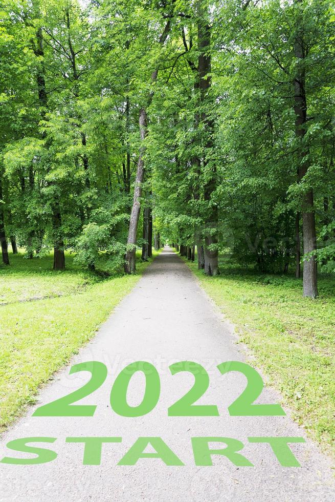 The concept of a road for business planning,the Word 2022, written on the road in the middle of trees in the park. photo