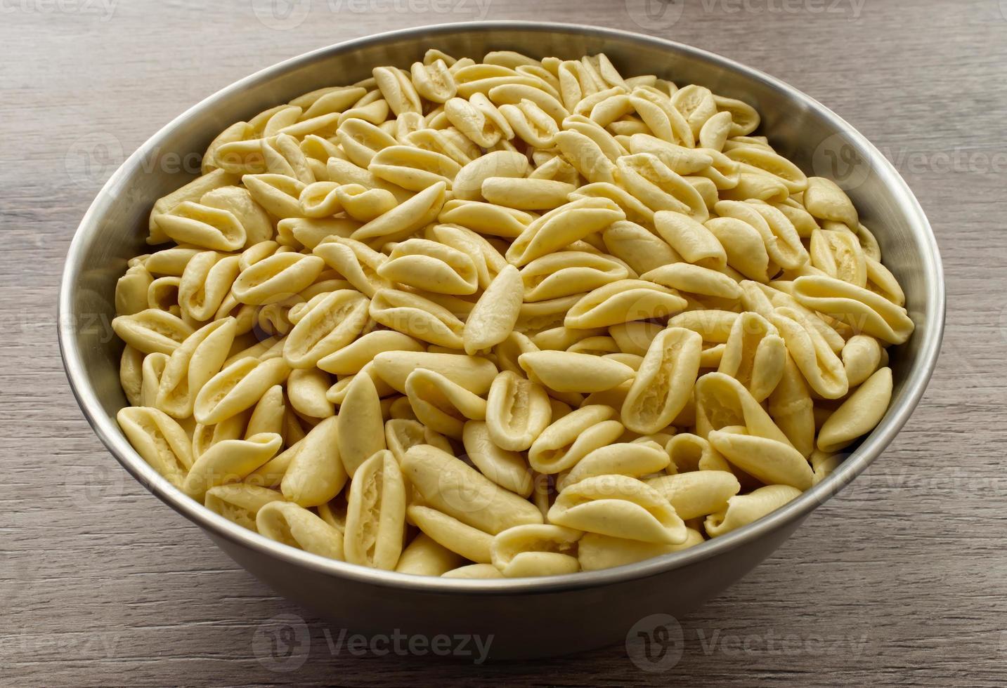 Traditional uncooked Italian Cavatelli. Cavatelli are a type of short pasta typical of Southern Italy, prepared only with semolina flour and water. photo