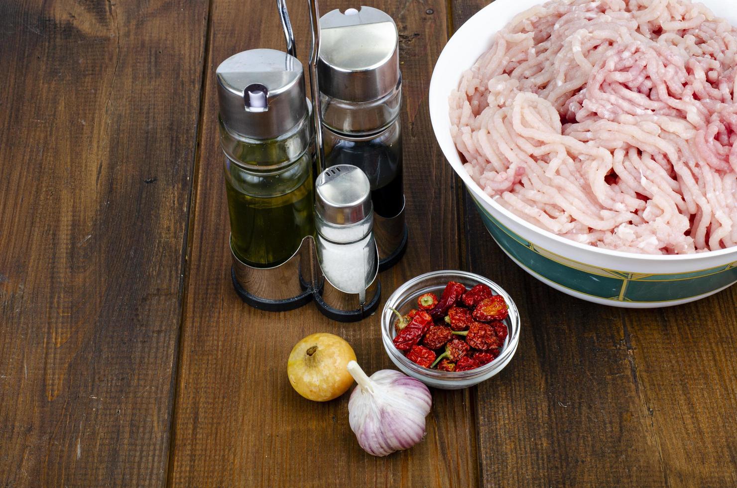 Plate with fresh minced meat, spices for cooking. Studio Photo