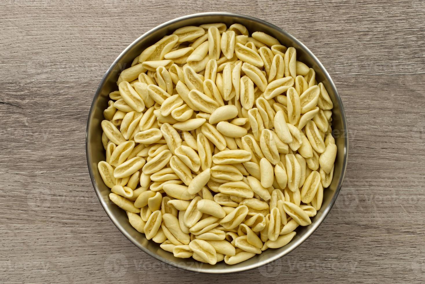 Traditional uncooked Italian Cavatelli. Cavatelli are a type of short pasta typical of Southern Italy, prepared only with semolina flour and water. Top view photo