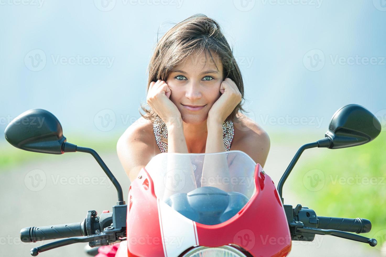 Close-up of a beautiful girl on top of the motorcycle photo