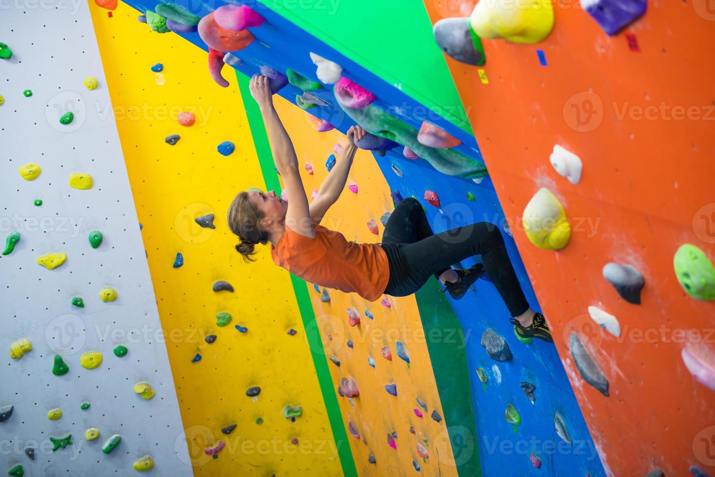 Girl during indoor climbing gym photo