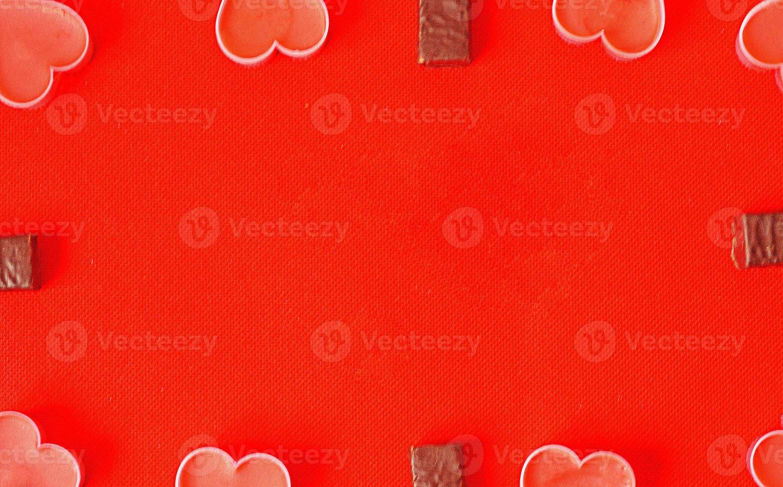 Happy valentines day.Many pink romantic hearts and chocolate candies on red background. Romantic Valentine day background photo