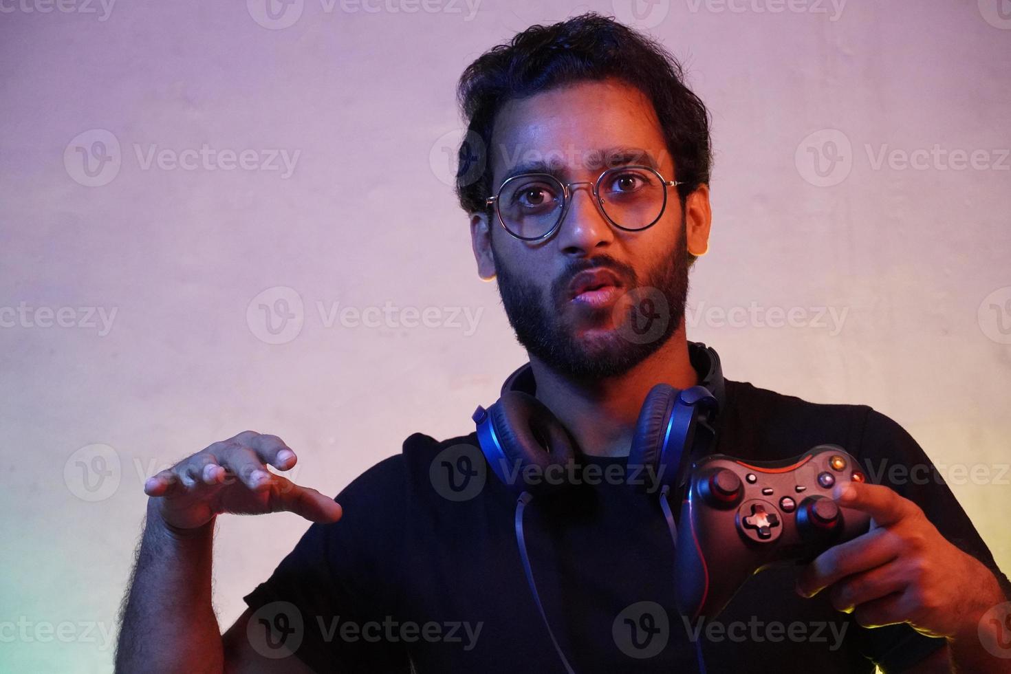 man wins game using playing video game using gaming wireless joystick- gaming concept photo