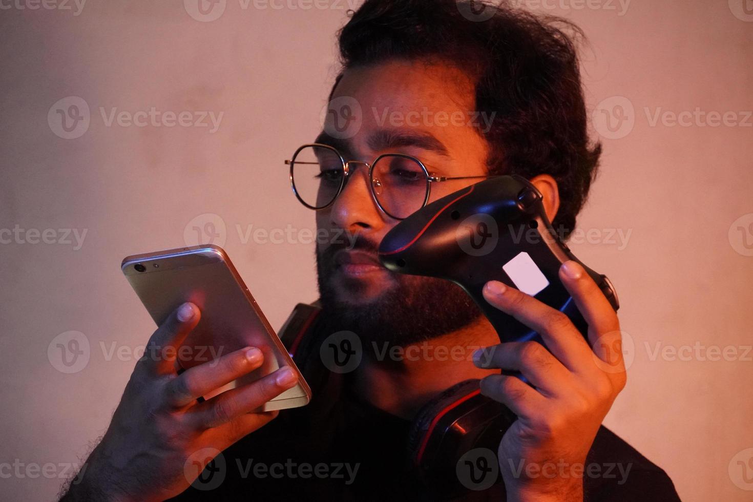 man using mobile and have gaming wireless joystick photo