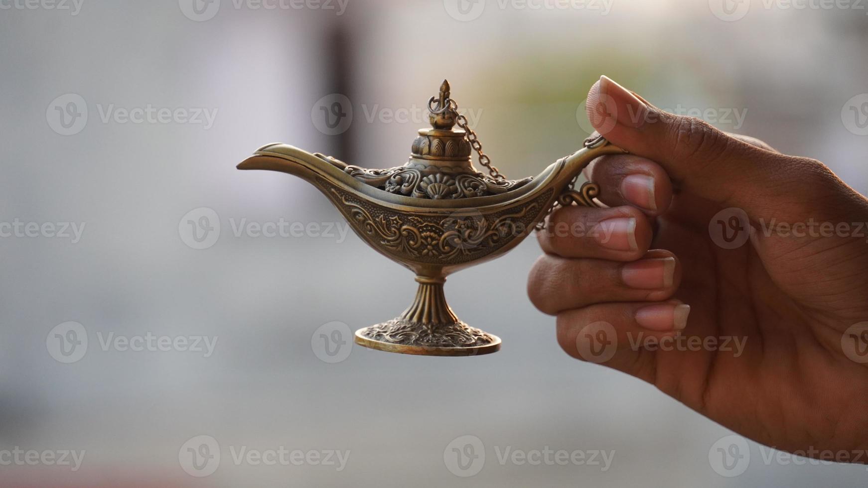 magical lamp in hand jinee lamp magical concept photo