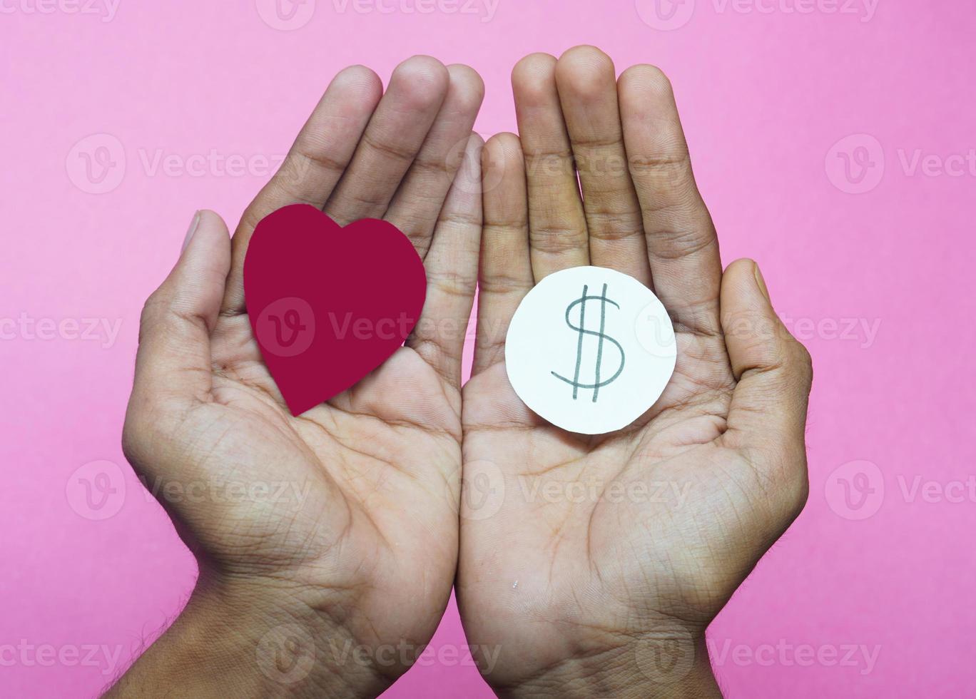 love needs money concept heart in hand dollors choose love or money photo