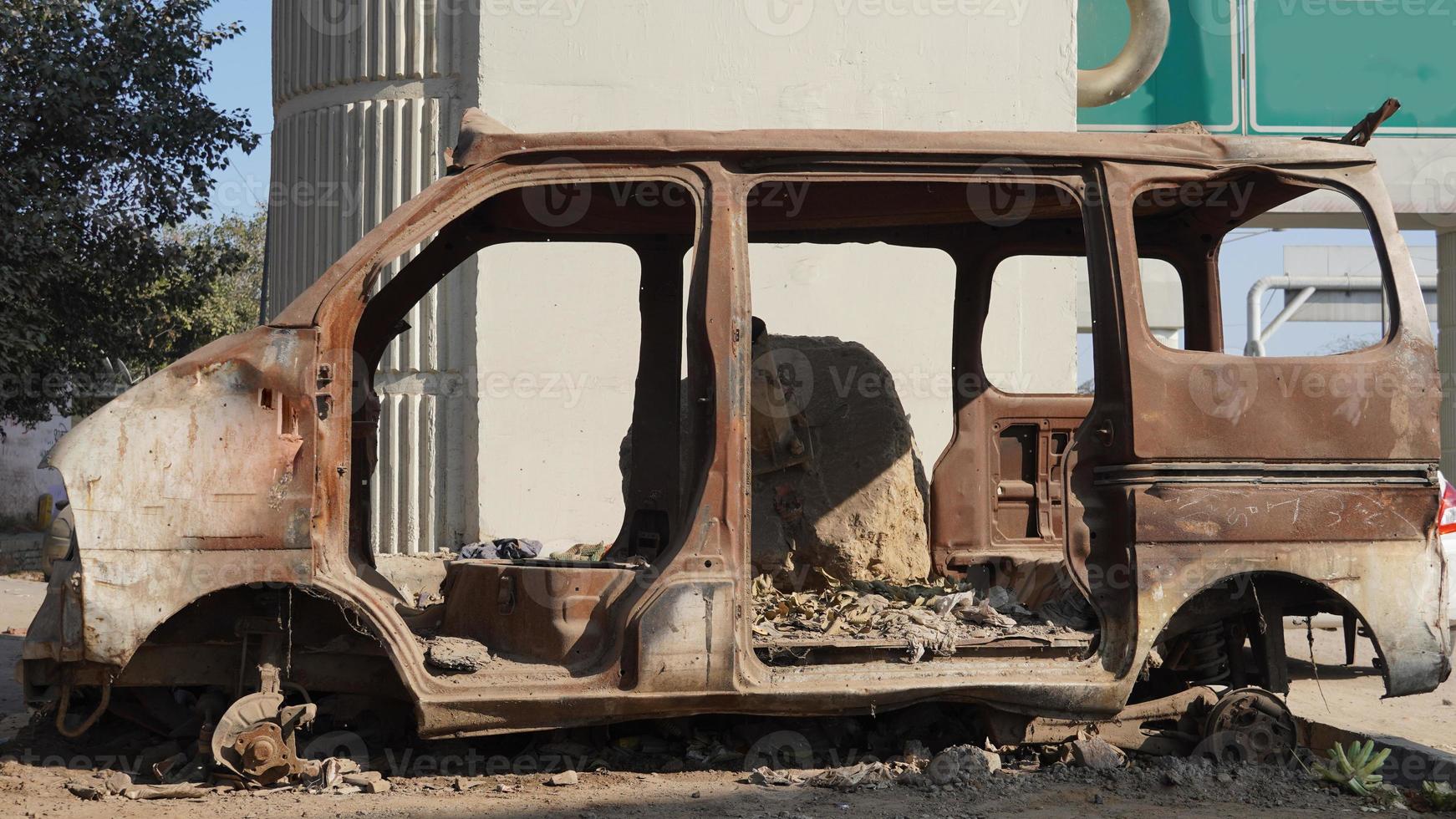 Old abandoned rusty vehicles, crushed cars in scrapyard, junk yard needed to be utilised and reused to protect nature and environment, metal recycling concept. photo