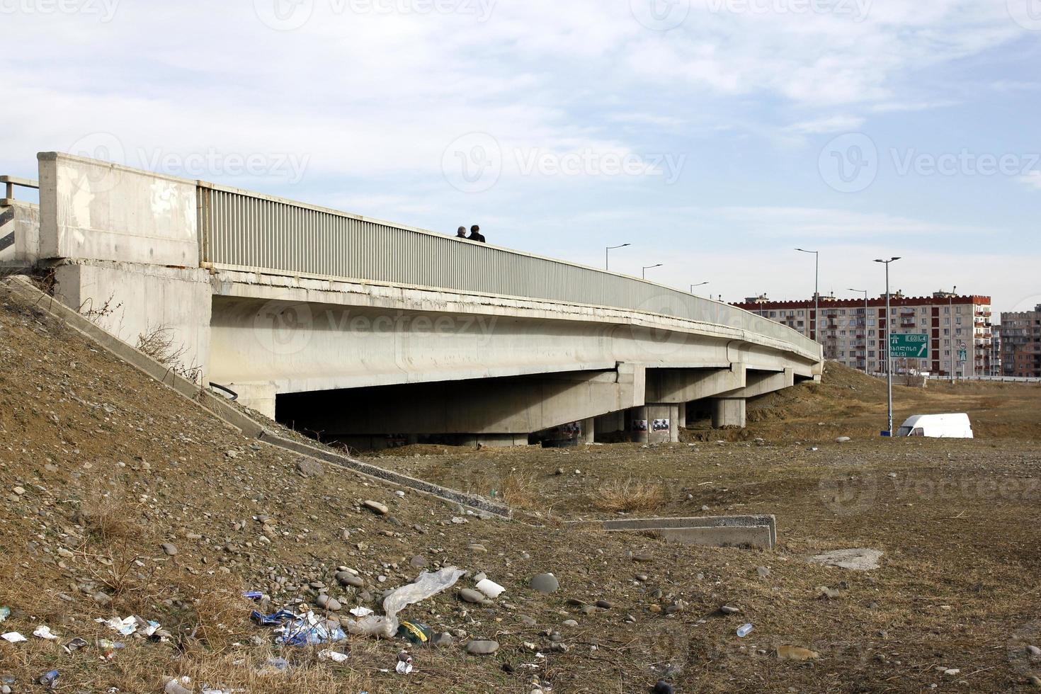 Elderly husband and wife walking on the bridge. photo