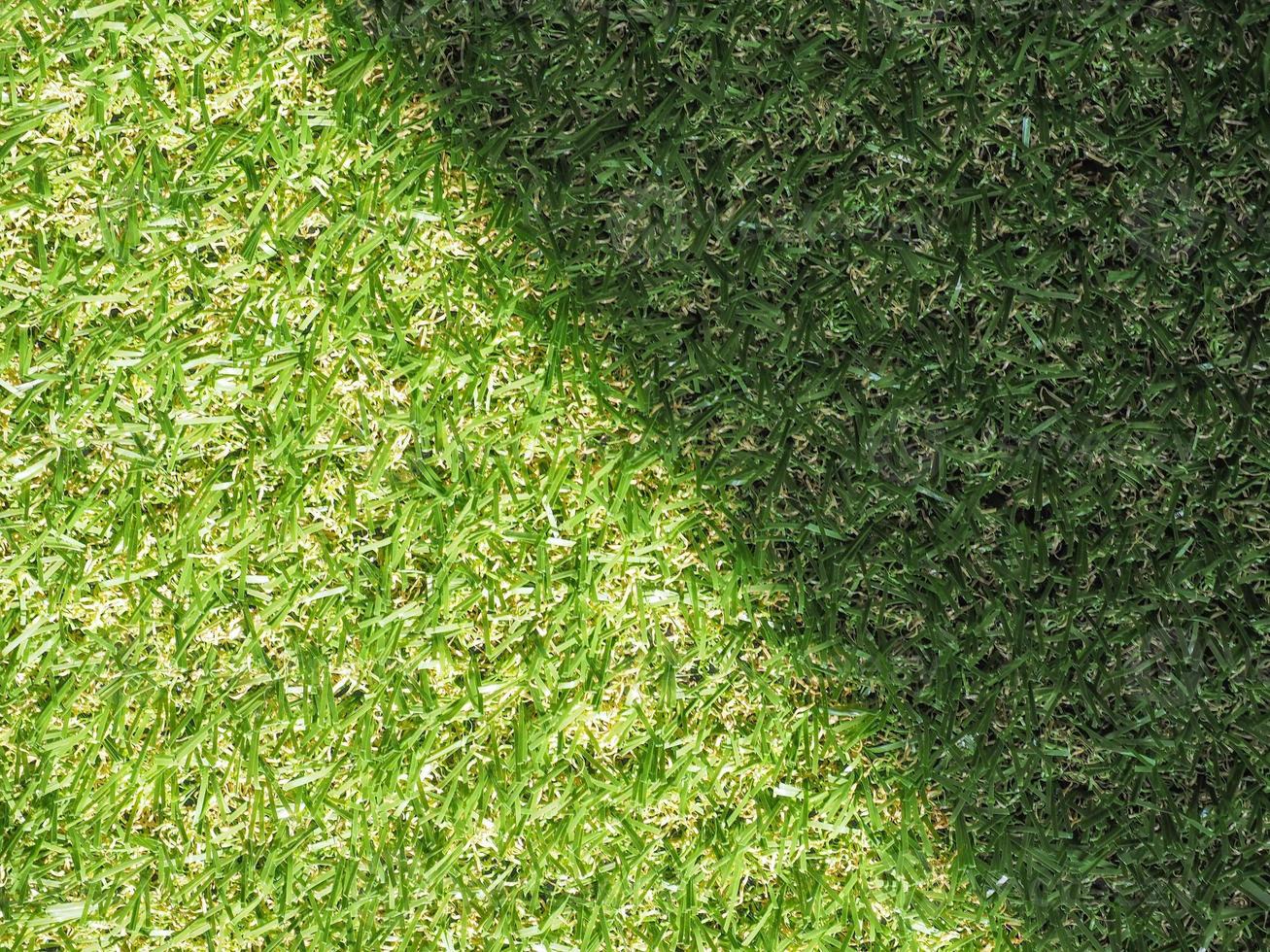 Green artificial synthetic grass meadow background photo