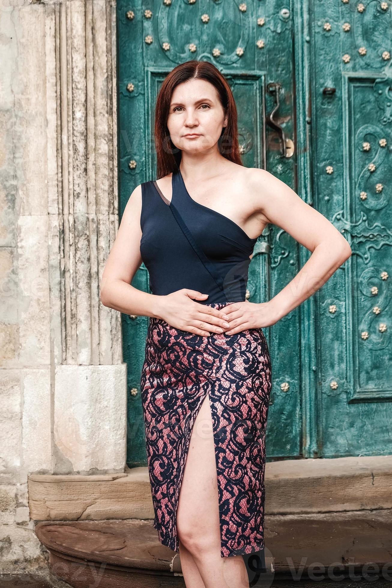 Beautiful woman in a sexy dress stands