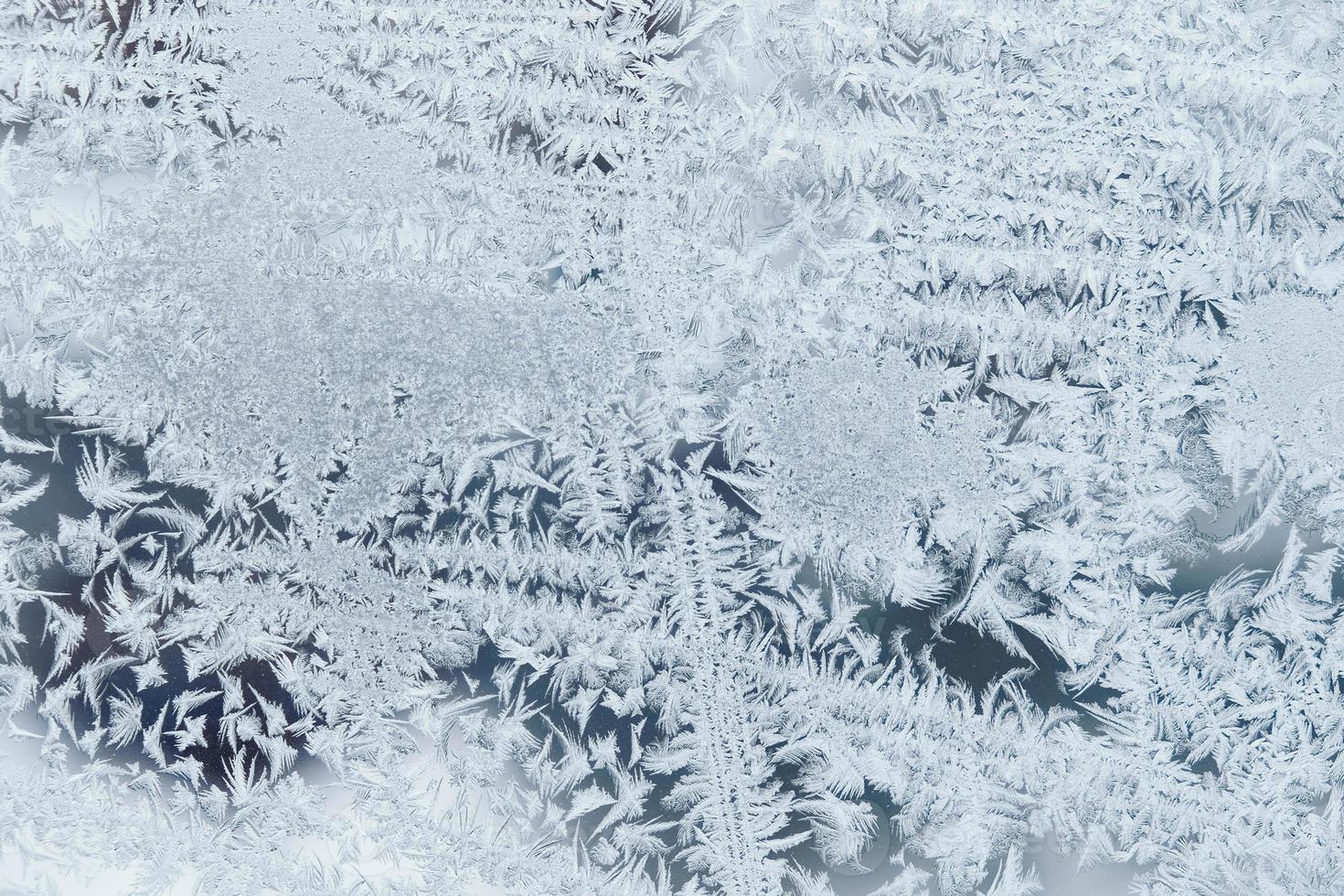 Ice patterns on frozen glass. Abstract ice pattern on winter glass as a background image photo