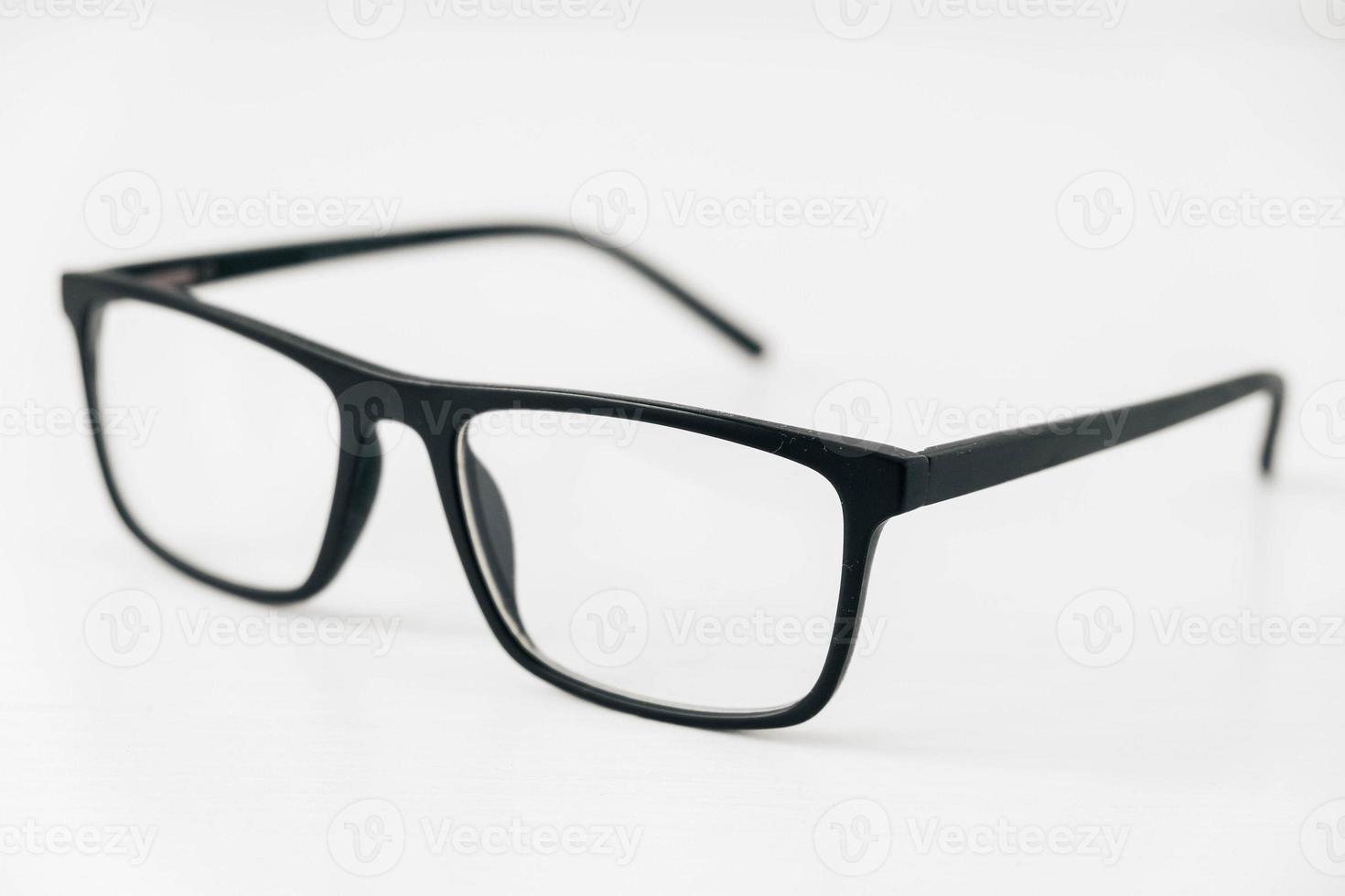 Optical glasses in a dark frame on a white background. Copy, empty space for text photo