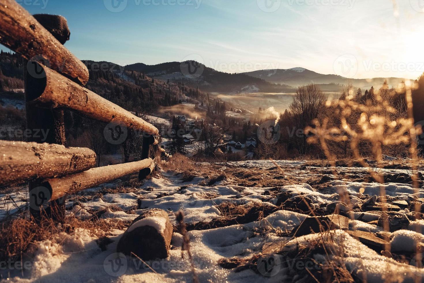 Winter landscape of snowy mountains at sunset. Mountain village in the Ukrainian Carpathians photo