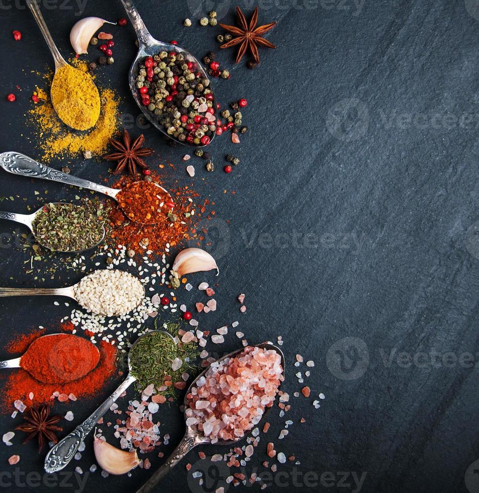 Different kind of spices in vintage spoons photo