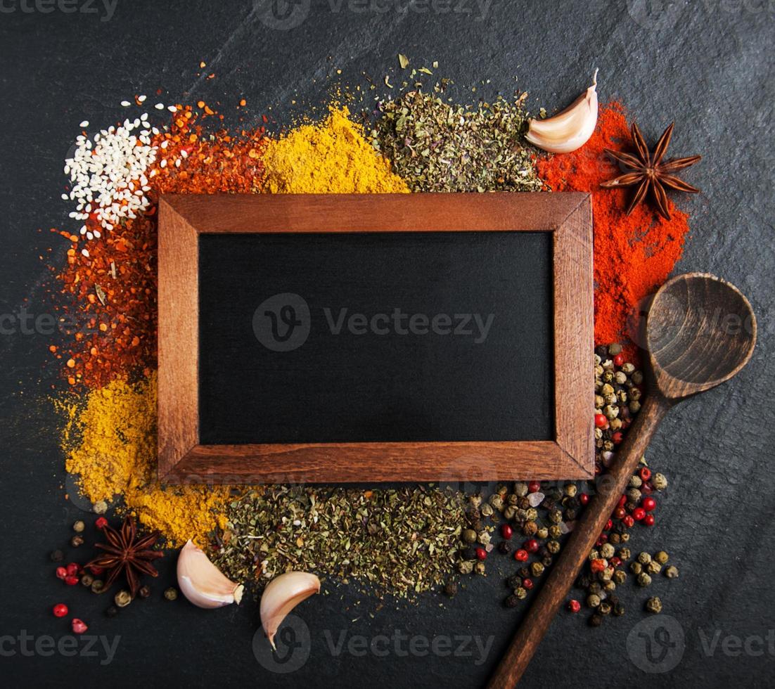 Different kind of spices and blackboard photo