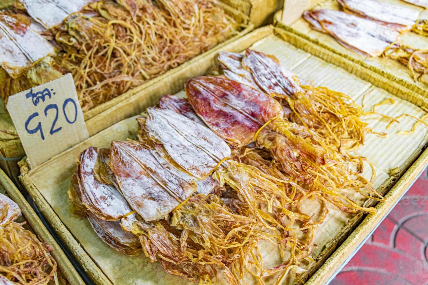 Buy dried squid Thai street food China Town Bangkok Thailand. photo