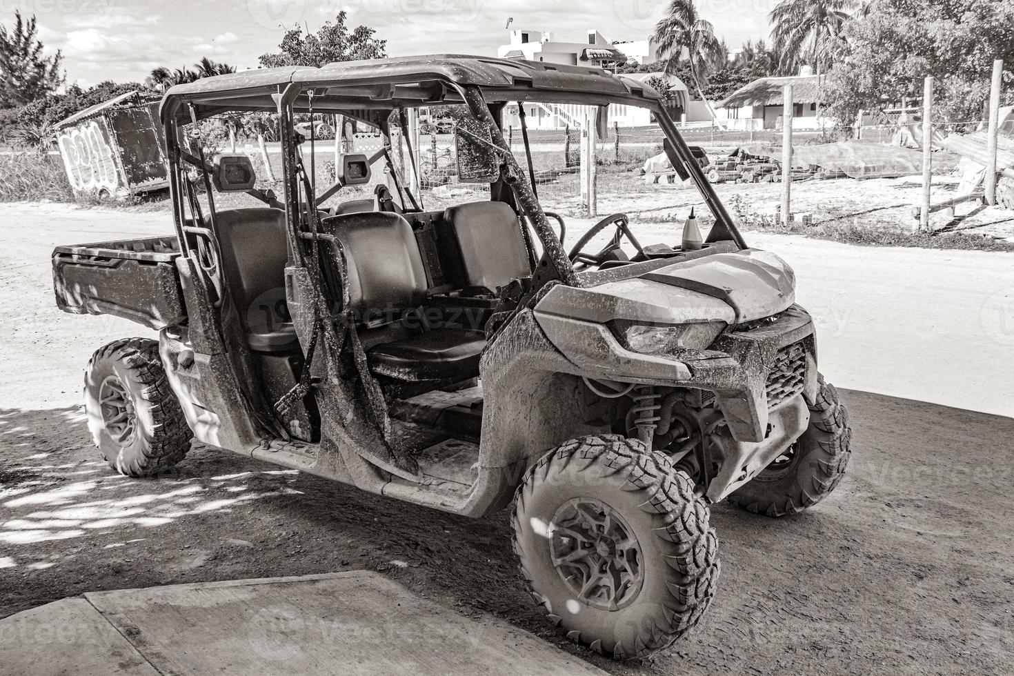 Buggy car golf cart carts muddy street village Holbox Mexico. photo