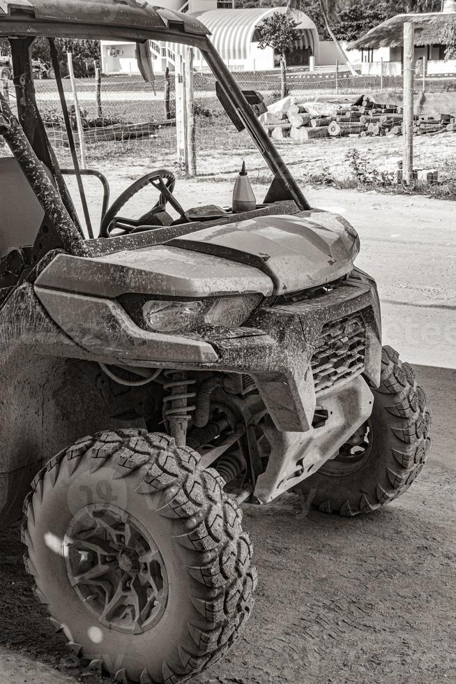 Buggy car golf cart carts muddy street village Holbox Mexico. photo