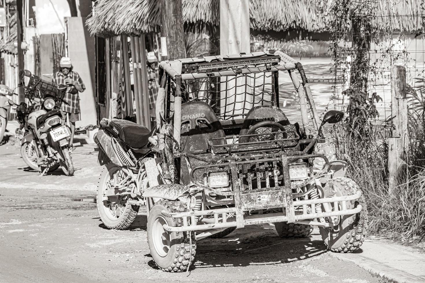 Holbox Mexico 22. December 2021 Golf cart buggy cars carts muddy street village Holbox Mexico. photo