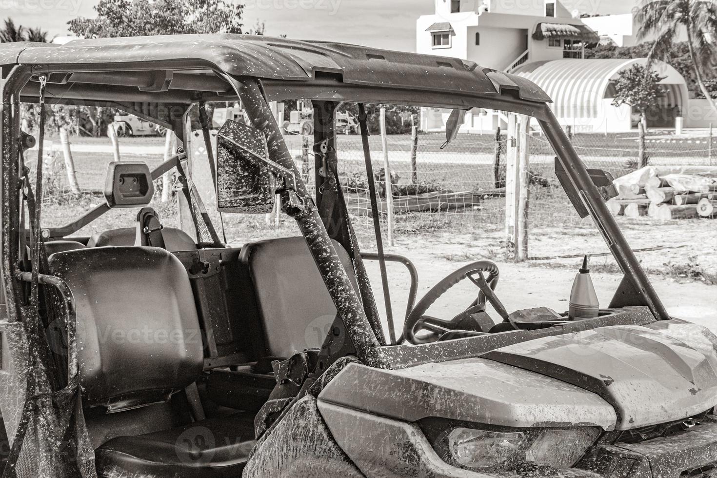 Buggy car golf cart carts muddy street village Holbox Mexico. photo