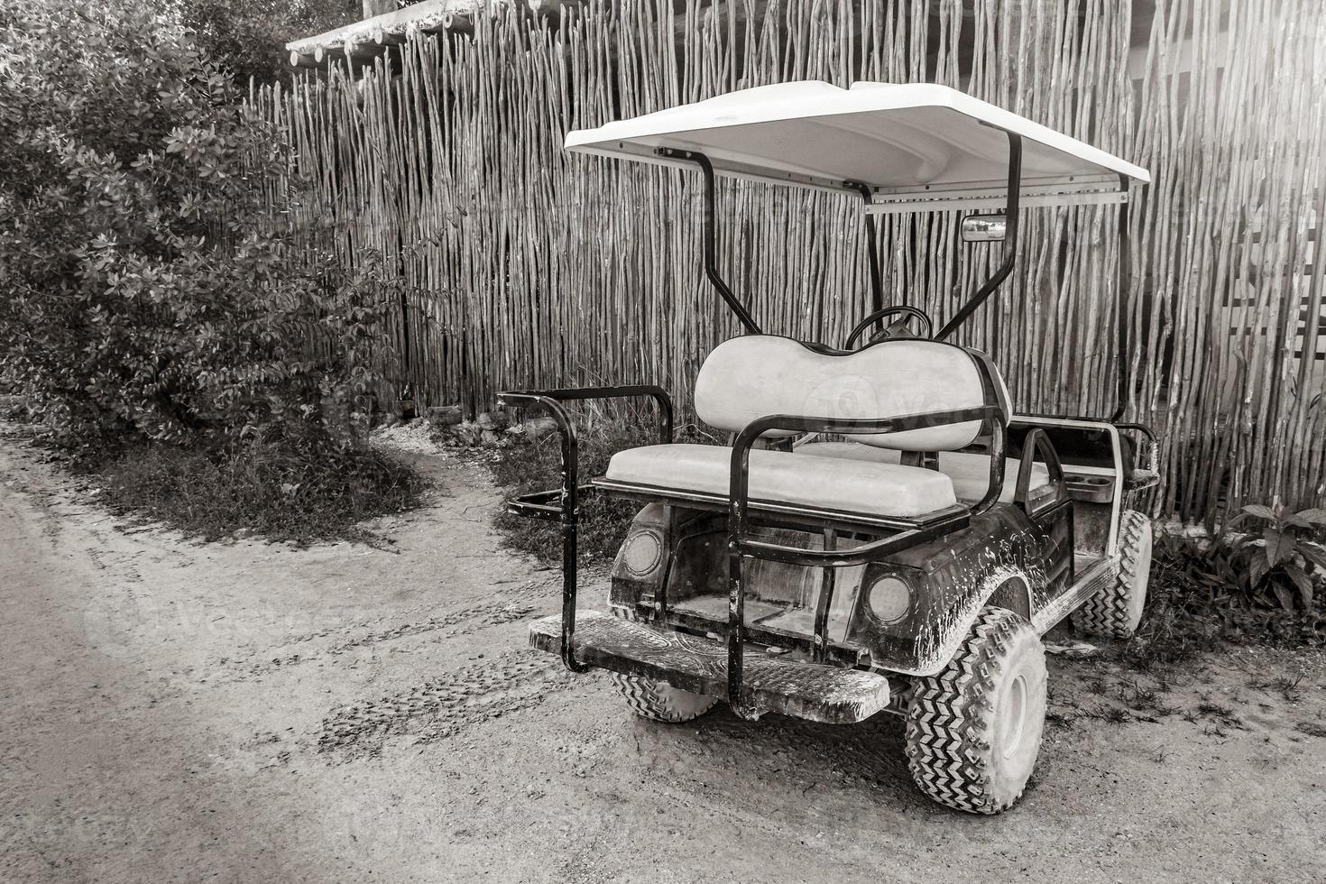 Golf cart buggy cars carts muddy street village Holbox Mexico. photo