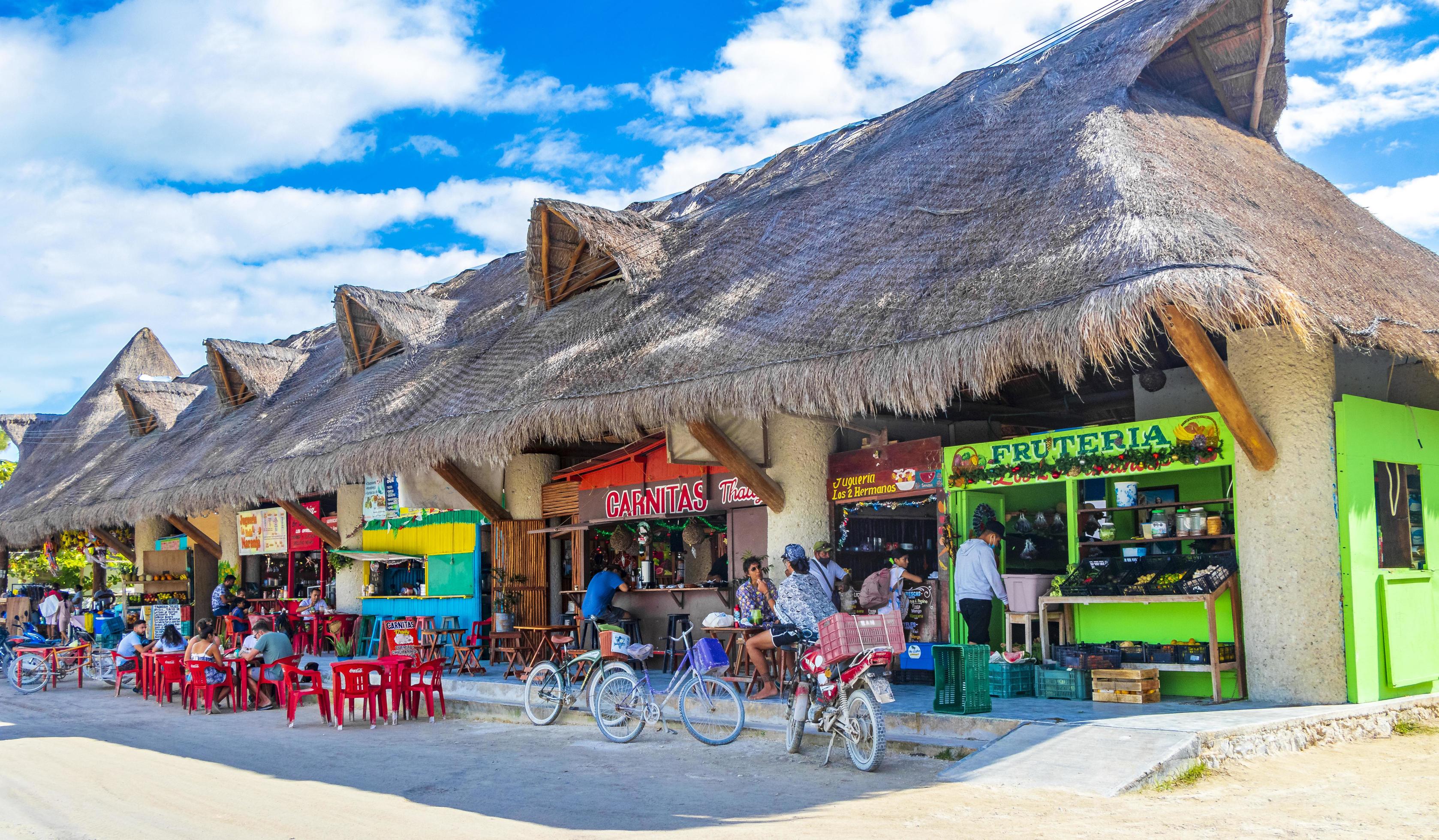 Holbox Mexico 22. December 2021 Colorful Holbox island village with stores mud and people Mexico