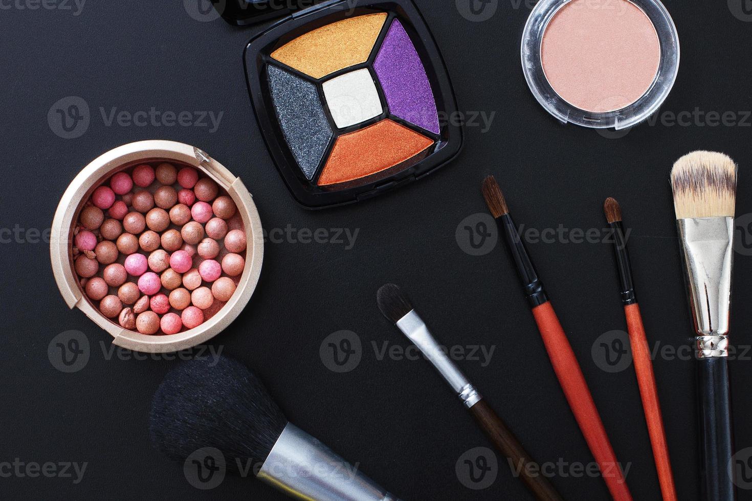 Cosmetics and make up products on black background. Copy space and mock up. Summer fashion photo