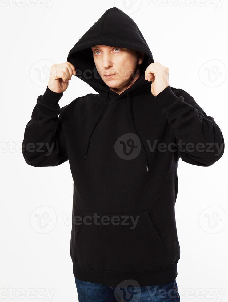 man in a black sweatshirt with a hood on his head is isolated on a white background photo