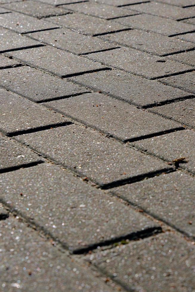 closeup of grey pavement made of rectangular paving stone, texture, background photo