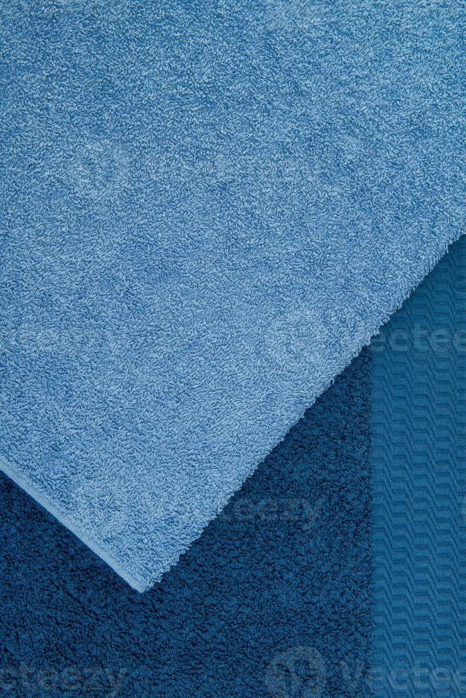 bath towel one on the other, blue. textured fabric background photo