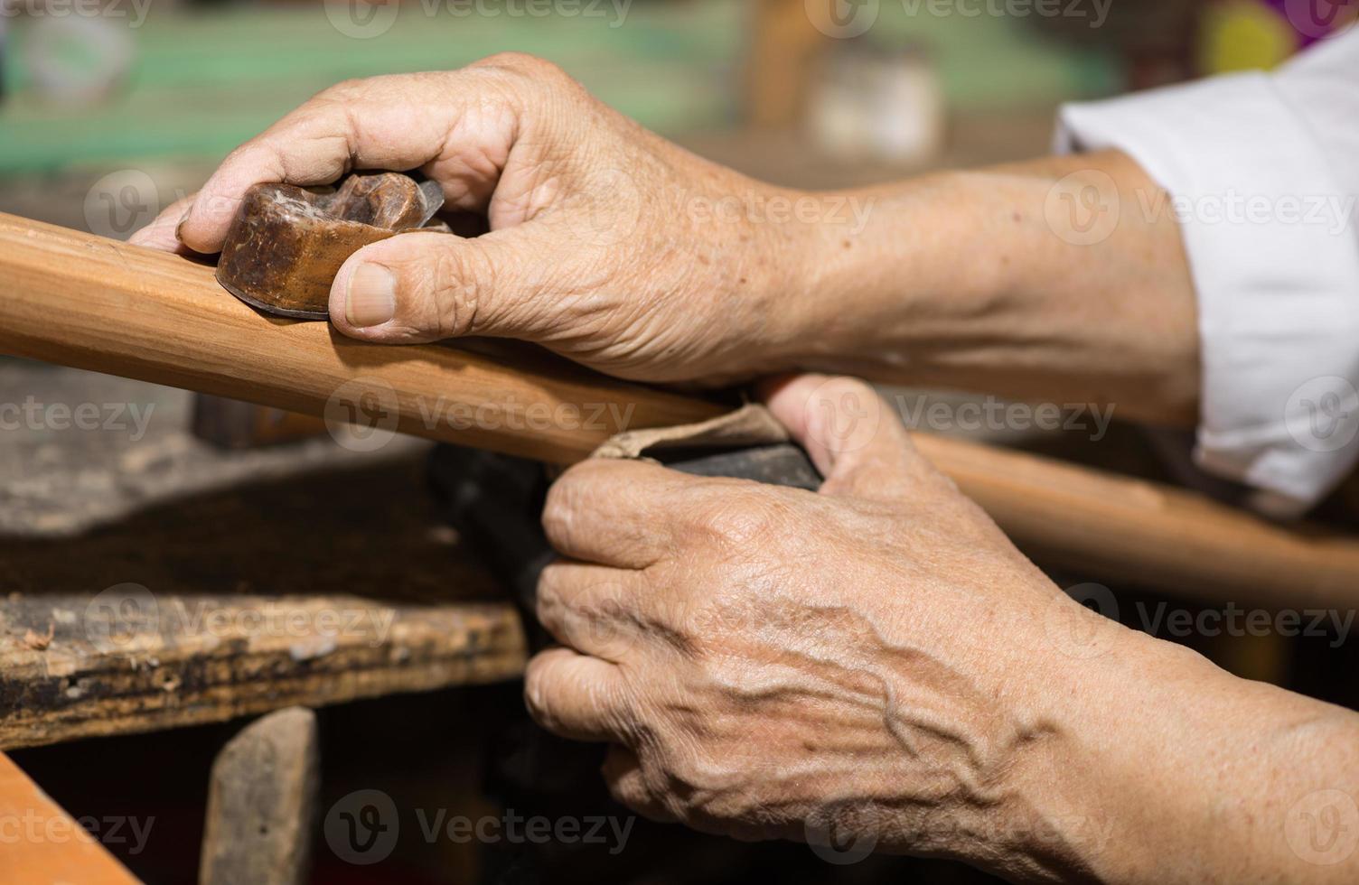 adult master restores old musical instruments. wood carving photo