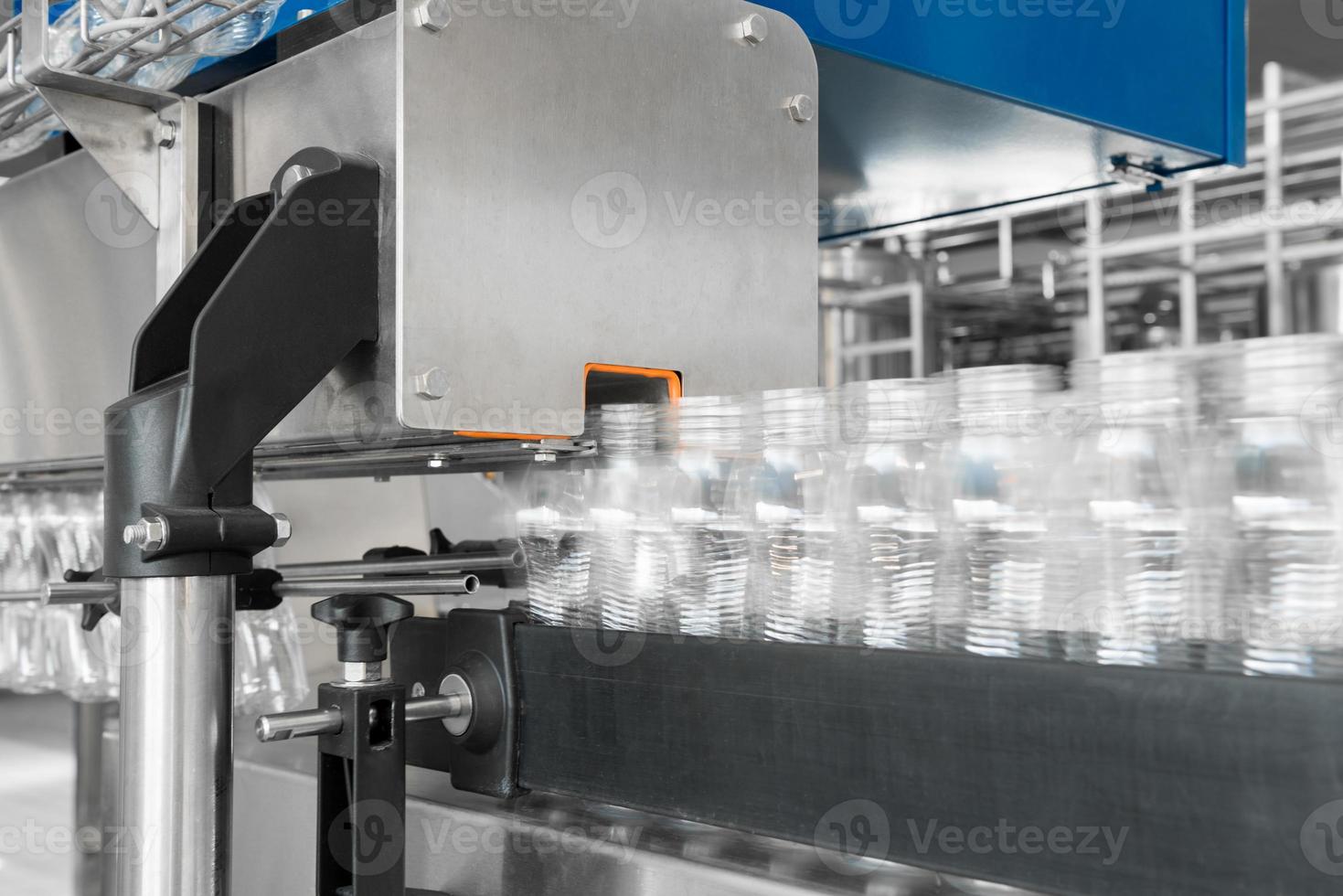 empty plastic bottles on conveyor belt. equipment at the dairy plant photo