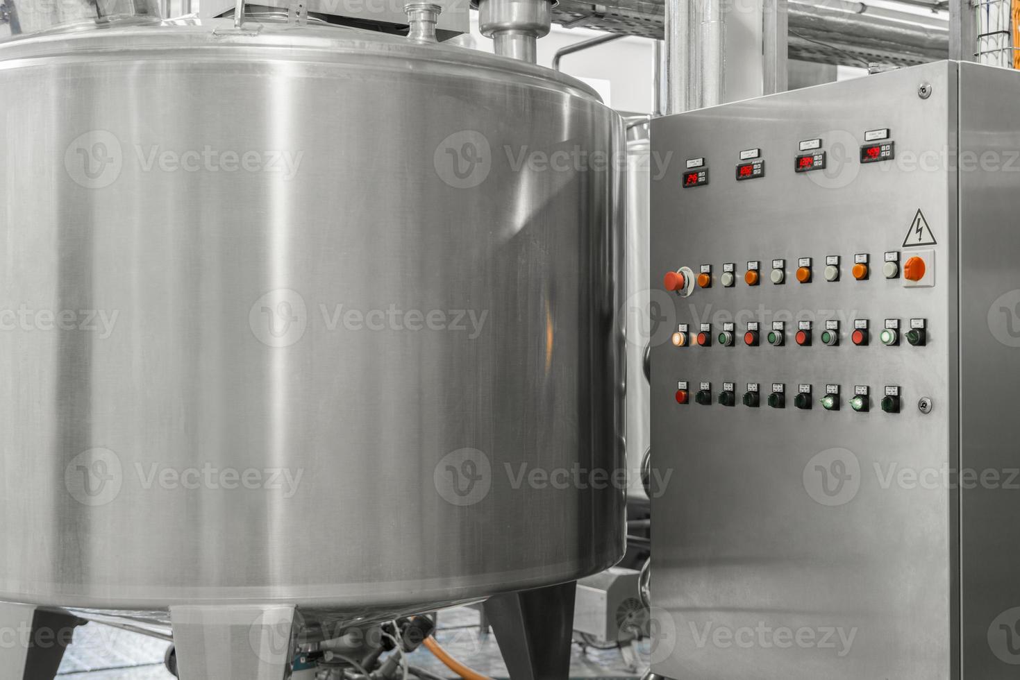 electronic control panel and tank at a milk factory. equipment at the dairy plant photo