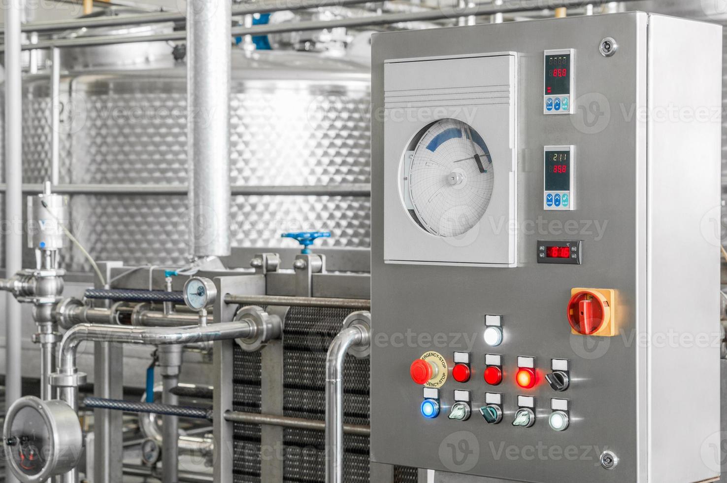 control panel with buttons and a tank at a beverage factory, close-up. factory shop for the production of glass bottles and beverage photo