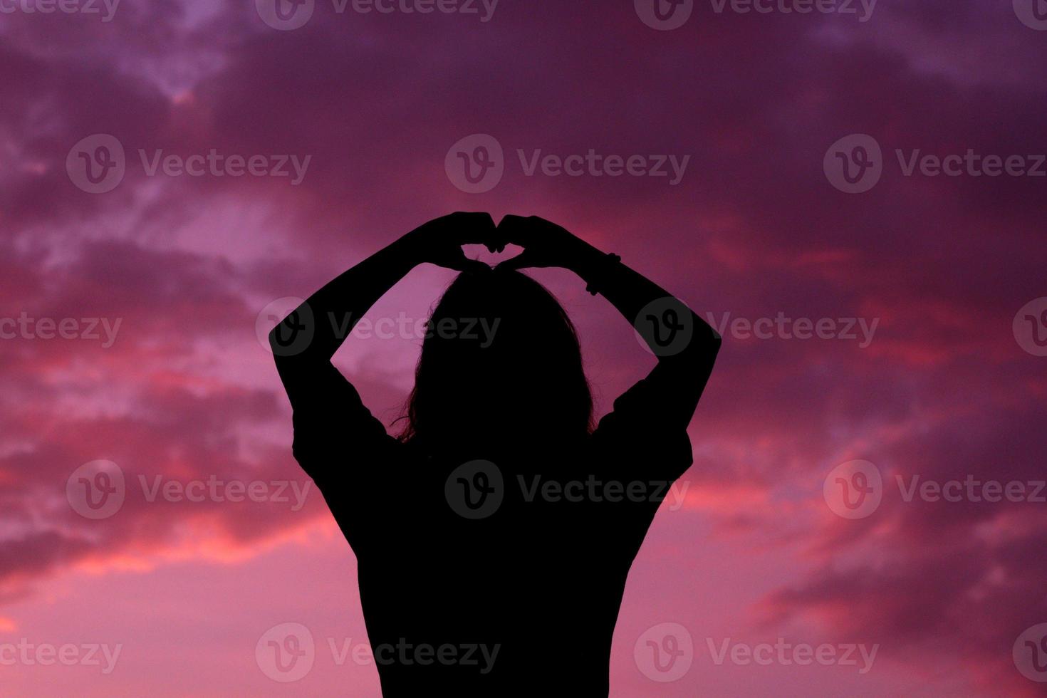 Silhouette medium shot of Woman or female standing with the sky sunset background on the sunset time. photo