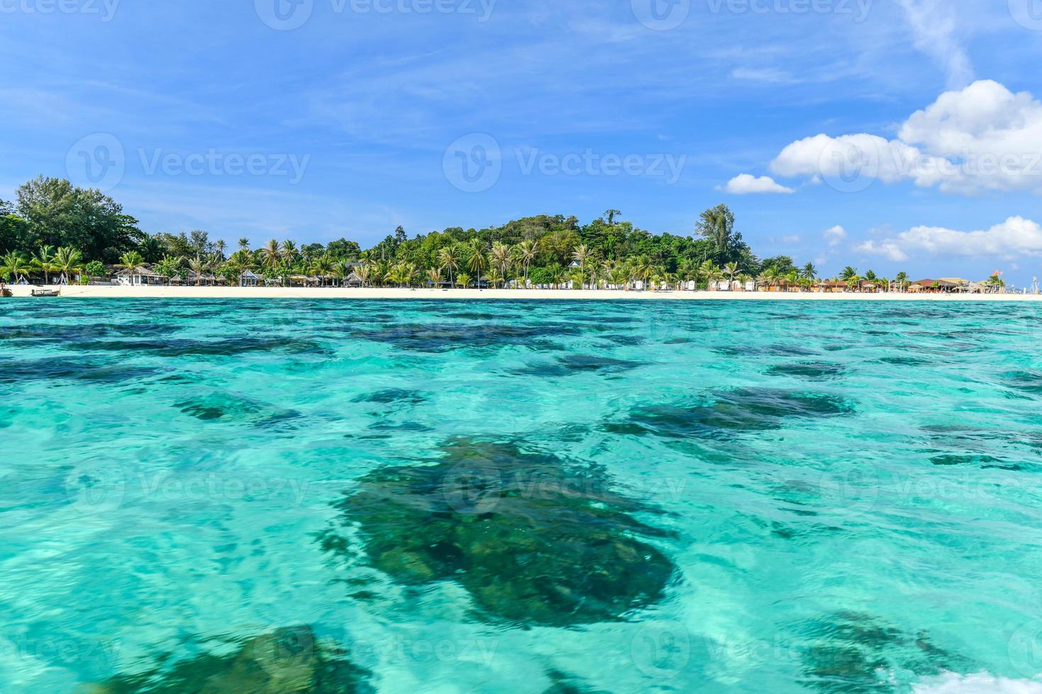 Pure white sand in front of beach resorts and a calm turquoise blue crystal clear sea Ko Lipe, Thailand photo